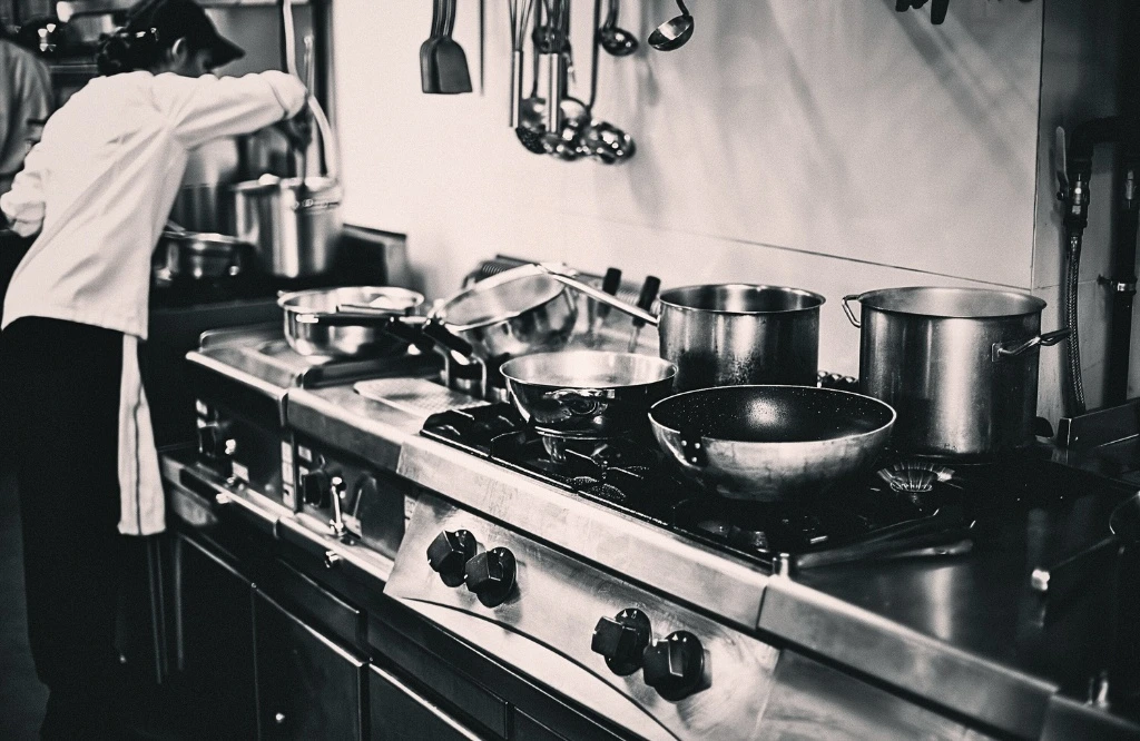 A man working in a kitchen and preparing a food for family