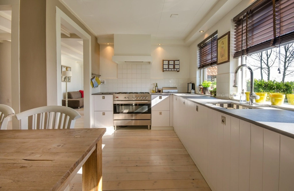 A kitchen with eco-friendly innovation, including a table and chairs for a sustainable touch.