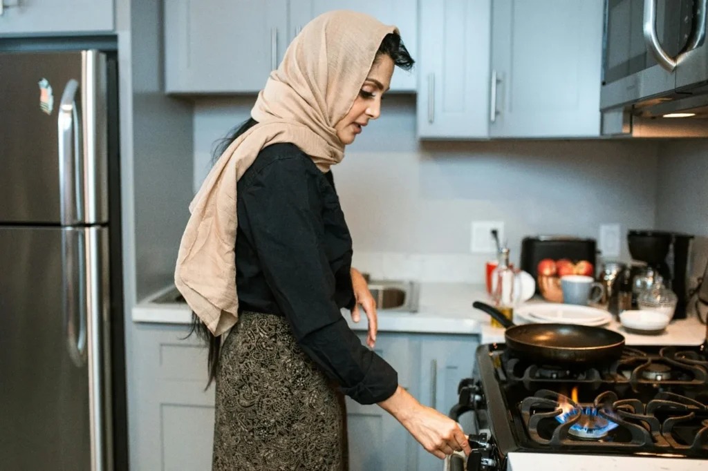 A women is switching ON the button of heating cabinet in a latest design kitchen