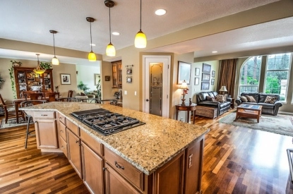 A big kitchen with a center island and countertops with a vast gallery.