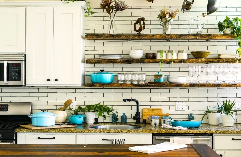 Modern kitchen featuring white cabinets and wooden counter tops for a sleek look.