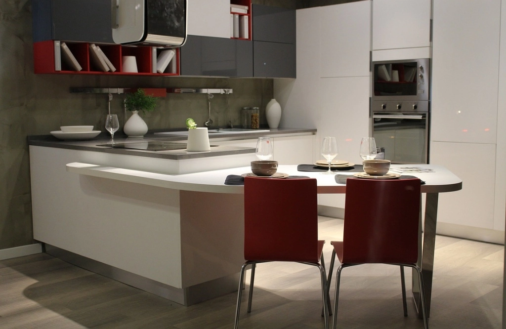 A modern kitchen featuring an elegant table and chairs, showcasing a blend of style and functionality in its design.