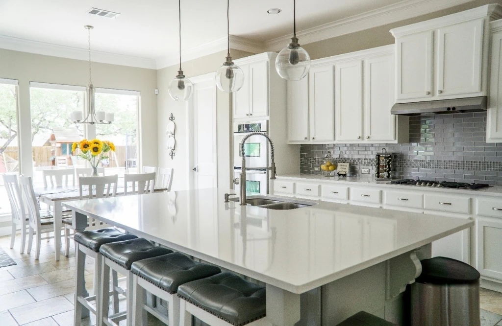 White cabinets and a center island in a kitchen, great for organizing your kitchen space.