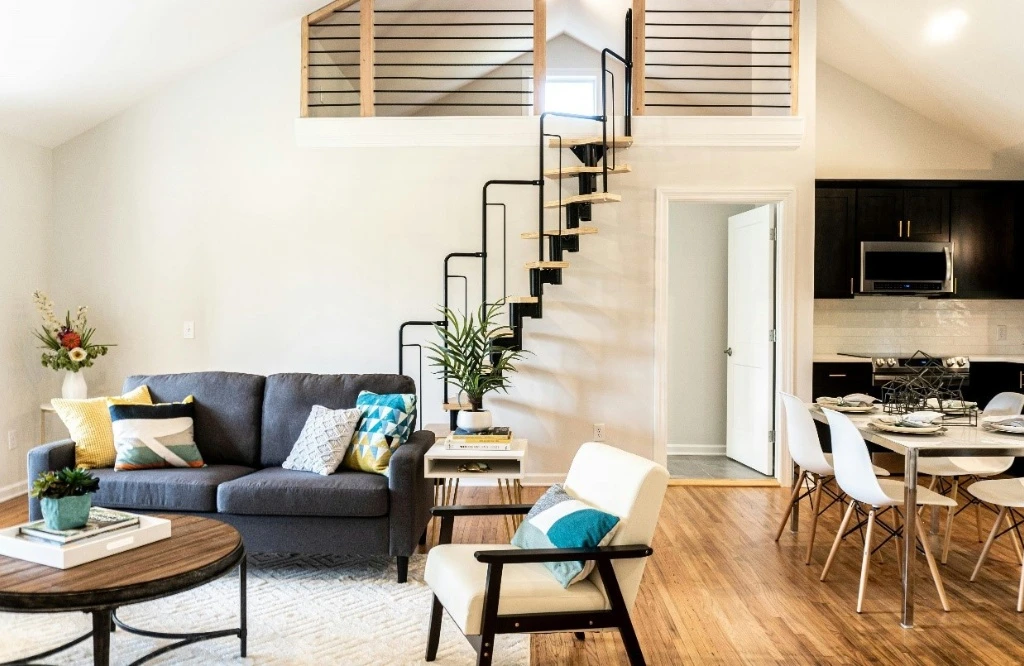 Cozy kitchen design with staircase to loft, perfect for relaxing or entertaining guests.