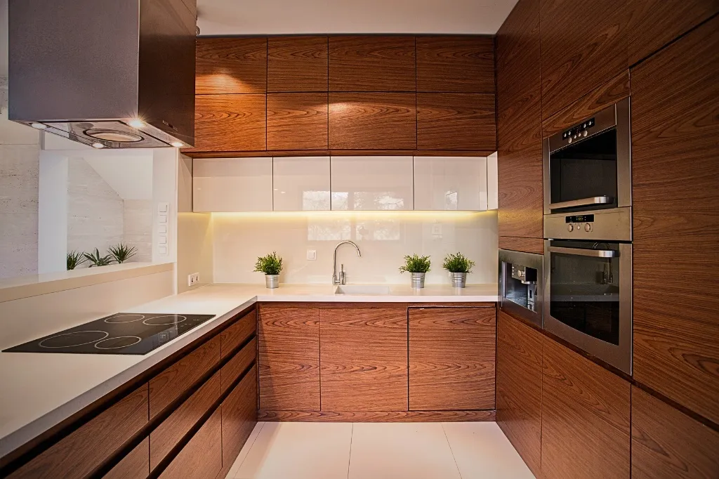 A modern kitchen with wooden cabinets and white countertops, designed within an average budget for kitchen cabinets renovation