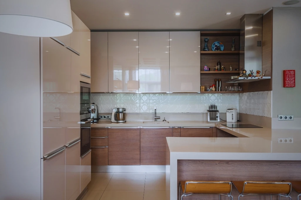 A modern kitchen scene displaying a sink, counter, and cabinets, highlighting the best cabinet sizes for your kitchen layout.