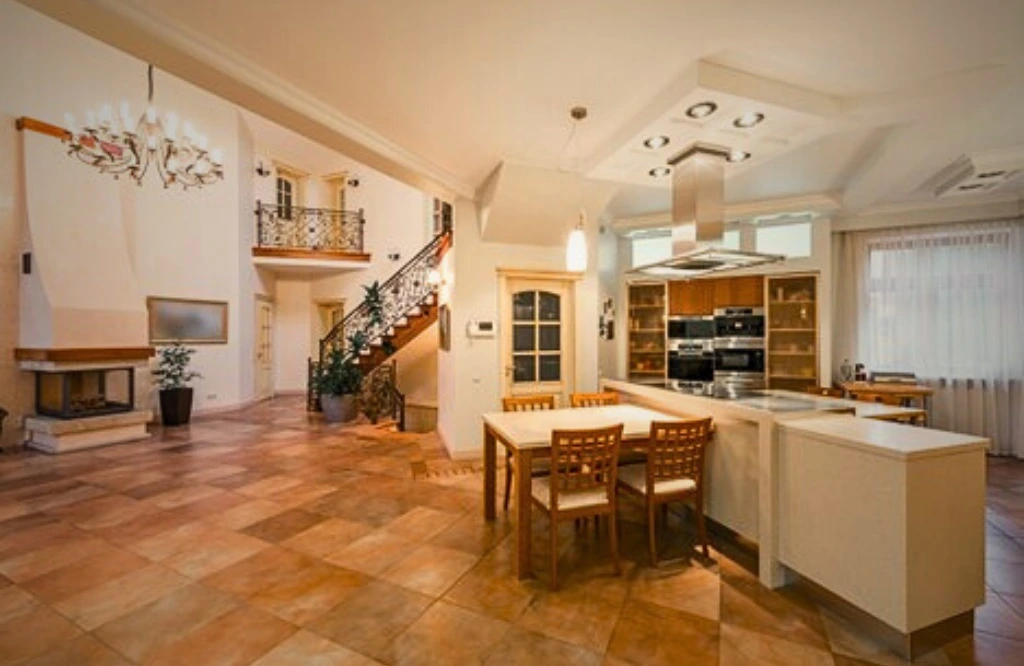 A stylish kitchen with open shelving and blue and white tiles, reflecting a modern aesthetic and organized space.