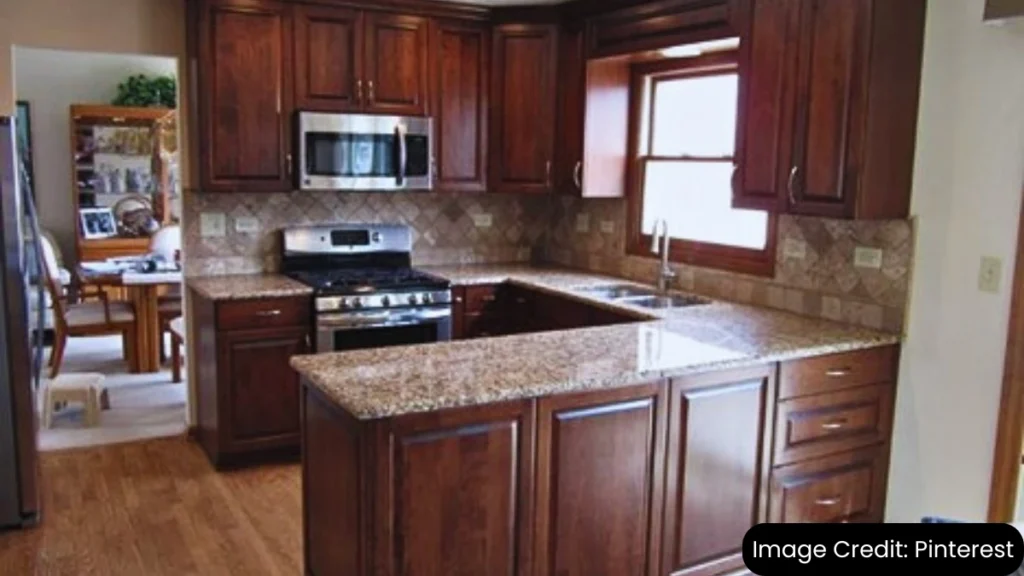 Custom kitchen cabinets in a warm wood tone with granite countertops and stainless steel appliances.