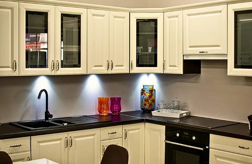 A well-organized kitchen featuring a table and chairs complemented by cabinets tailored to your storage requirements.