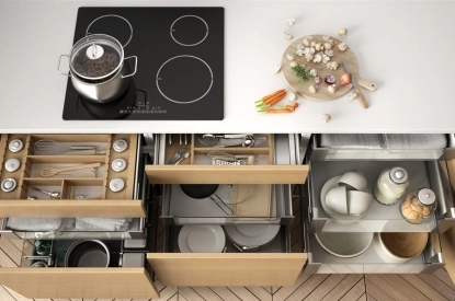 A modern kitchen featuring organized drawers, pots, and pans, showcasing stylish decor and accessories for remodeling.