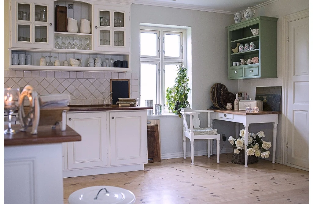 A kitchen with a white table and chairs featuring an enhanced work surface.