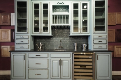 A household kitchen adorned with blue cabinets and a wine rack, exemplifying elegance and practicality in home decor.