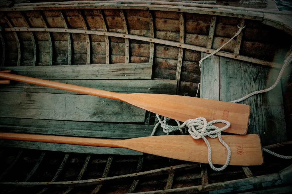 A step-by-step guide on how to restore old wooden oars, showcasing tools and techniques for a successful restoration.