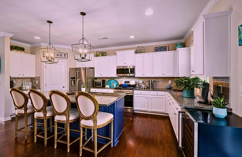 The kitchen has white cabinets, blue countertops, and improved seating alternatives for the kitchen island.