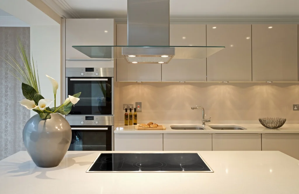 Contemporary kitchen showcasing a white countertop, a decorative vase, and spacious kitchen islands for added convenience.