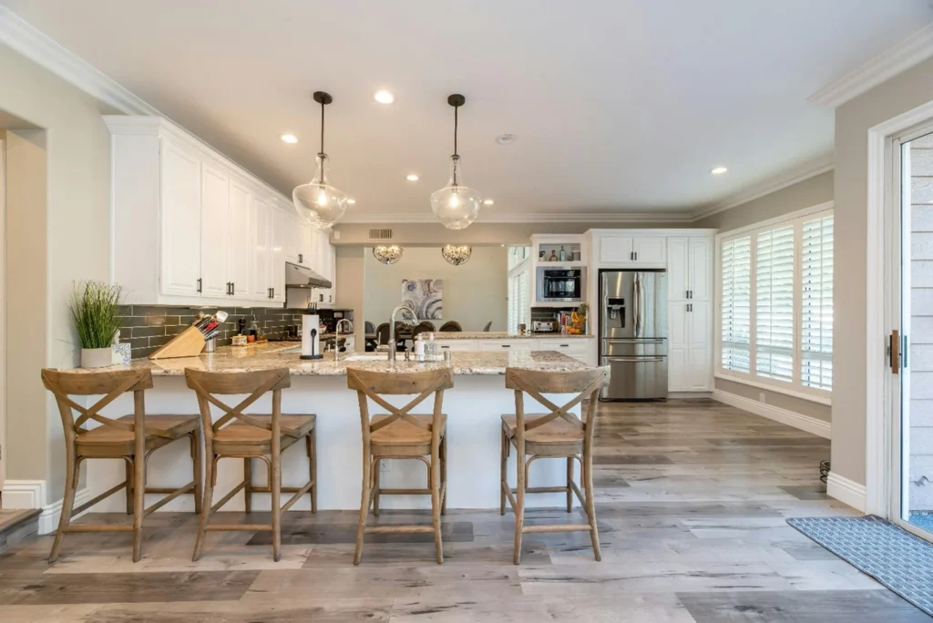 A modern kitchen with dining table showcase the factors which effect kitchen