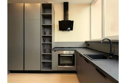 A modern kitchen with sink, oven, and refrigerator in a medium-sized home kitchen.