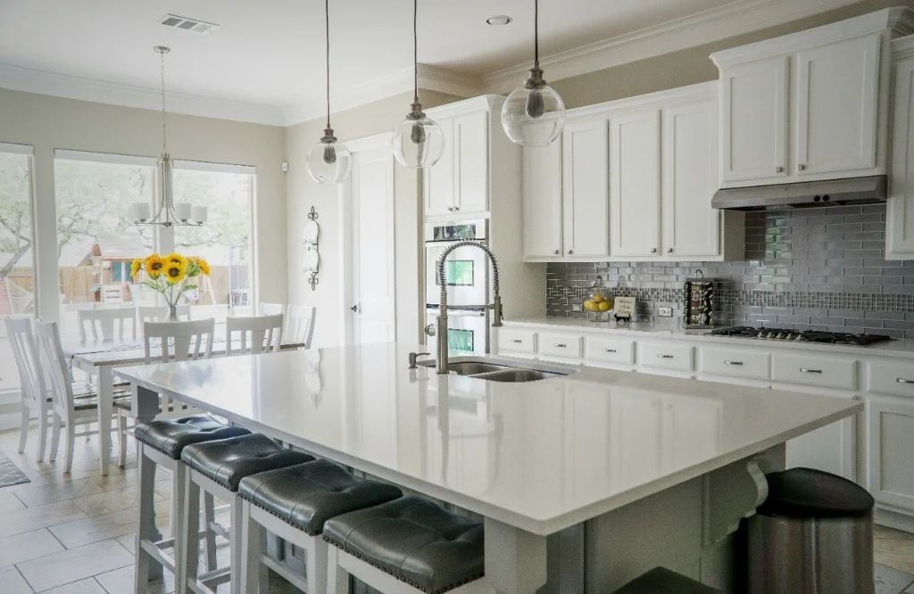 A modern kitchen featuring white cabinets and a central island showcasing a sleek and contemporary design aesthetic.