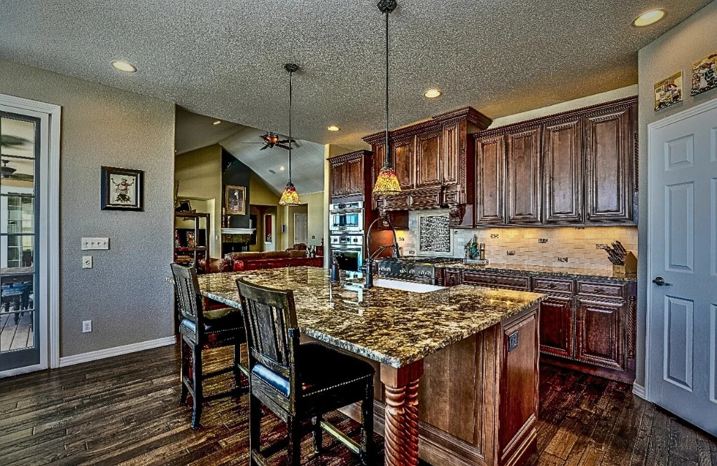 A modern kitchen featuring a center island and elegant hardwood floors showcasing a stylish and functional design.