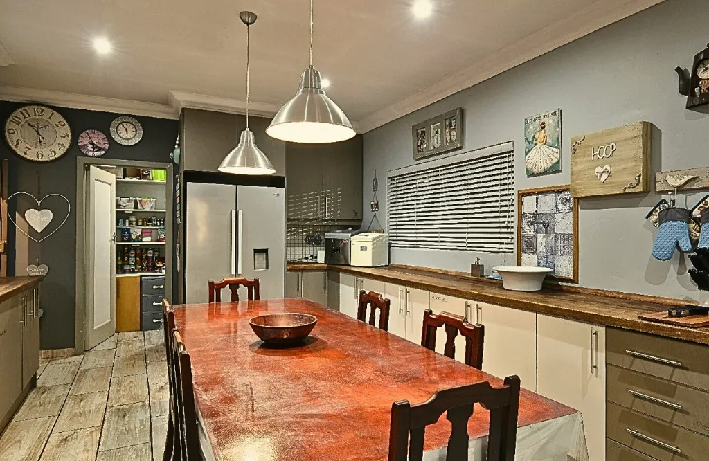 A modern kitchen featuring white cabinets, black countertops, and ample storage space for all your culinary needs.