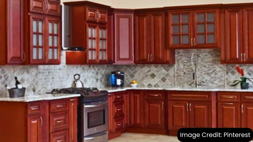 Traditional kitchen with cherry wood raised-panel cabinets and tile backsplash.