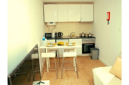 Stylish kitchen in a small rental apartment, showcasing innovative storage solutions and contemporary decor.