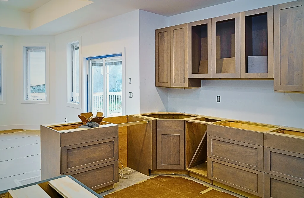 An image of a kitchen showcasing unfinished cabinets and countertops emphasizing the need for investment in cabinetry.