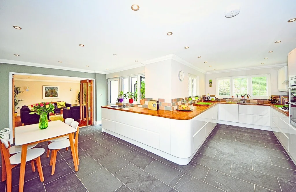 A modern kitchen showcasing a table and chairs, serving as a stylish focal point for meals and social interactions.