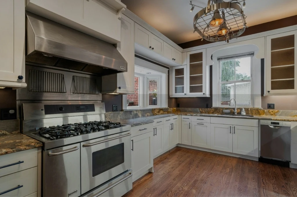 A stylish kitchen showcasing stainless steel appliances and warm wood floors, perfect for Ultimate Guide to Choosing Kitchen Cabinets