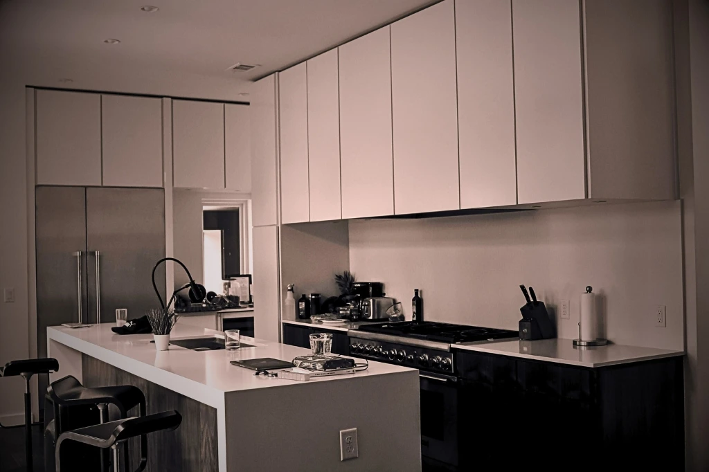 A warm kitchen scene showcasing a stove and sink, embodying tips for creating a cozy cooking environment.