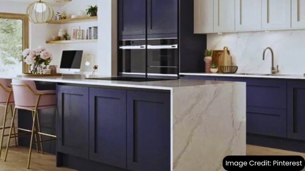 Modern kitchen with two-tone cabinets in navy blue and white, featuring a marble island and open shelving.