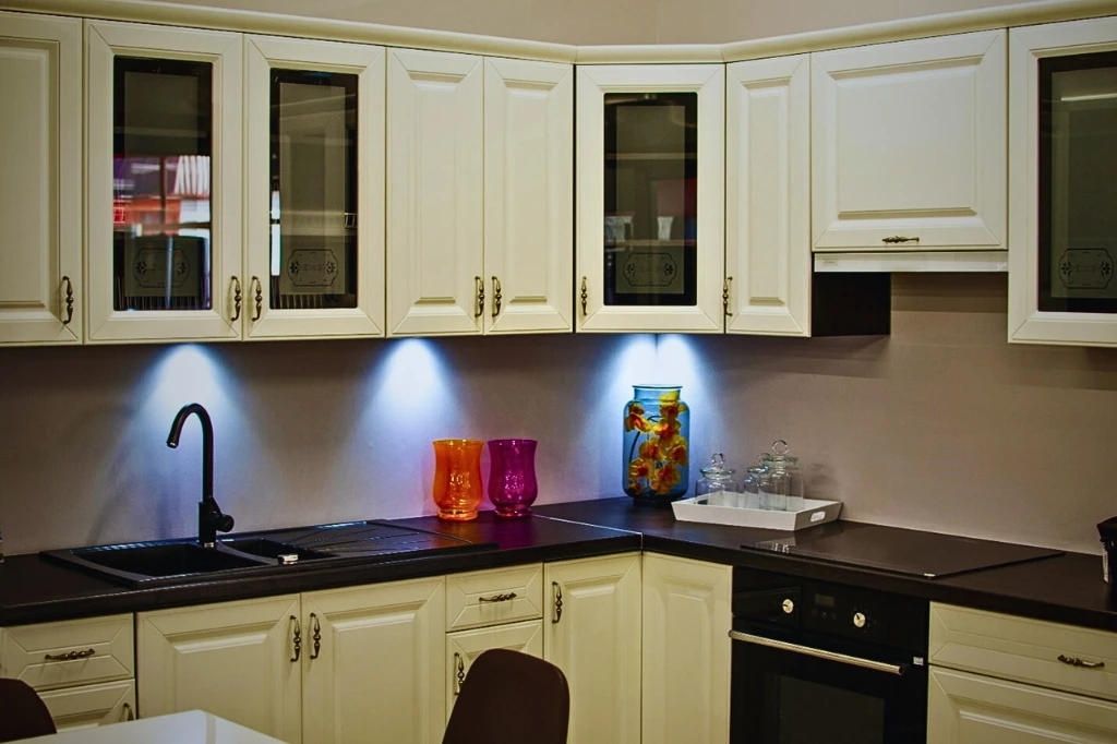 A modern kitchen featuring what are shaker-style white cabinets and sleek black countertops, creating a stylish contrast.