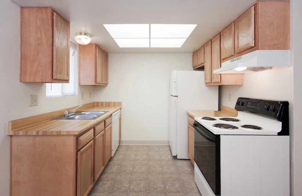 How to fill wide kitchen layout equipped with a stove, refrigerator, and microwave, emphasizing a modern and functional cooking space.