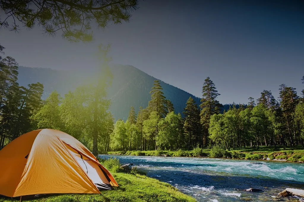 Orange tent by a blue river in a forested area, depicting potential summer cooking camp environment.