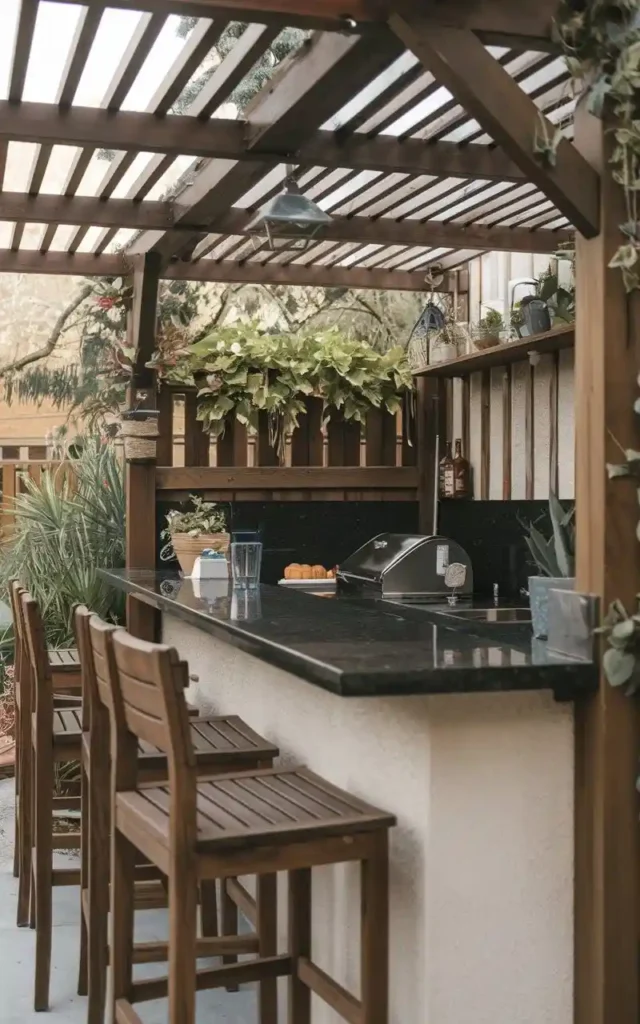 small covered outdoor kitchen with wooden stools and granite countertop