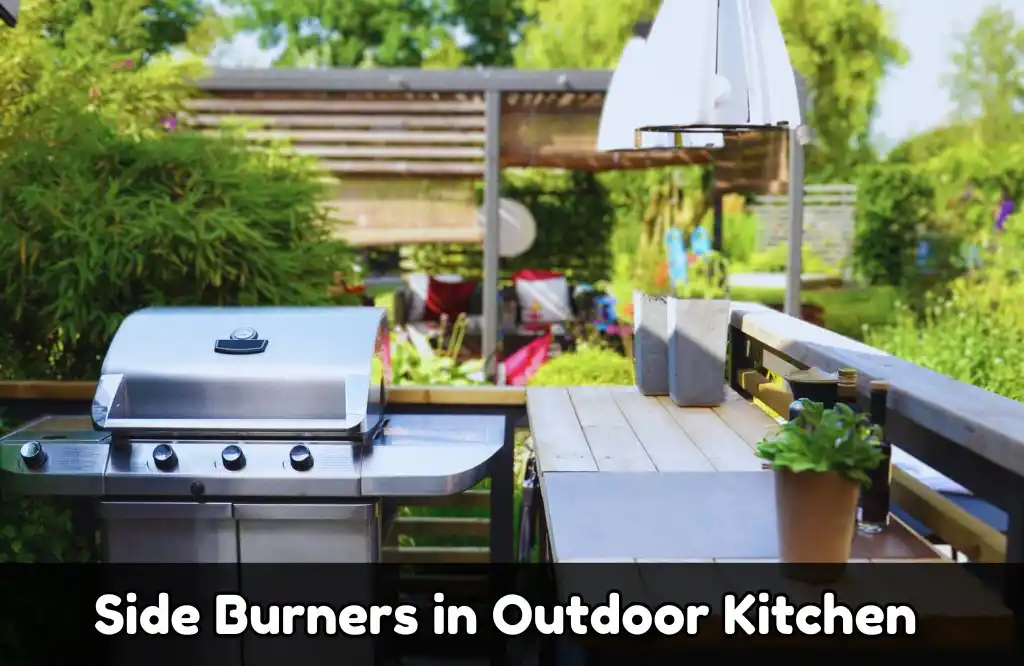 A stainless steel grill with side burners in a modern outdoor kitchen, featuring a wooden countertop