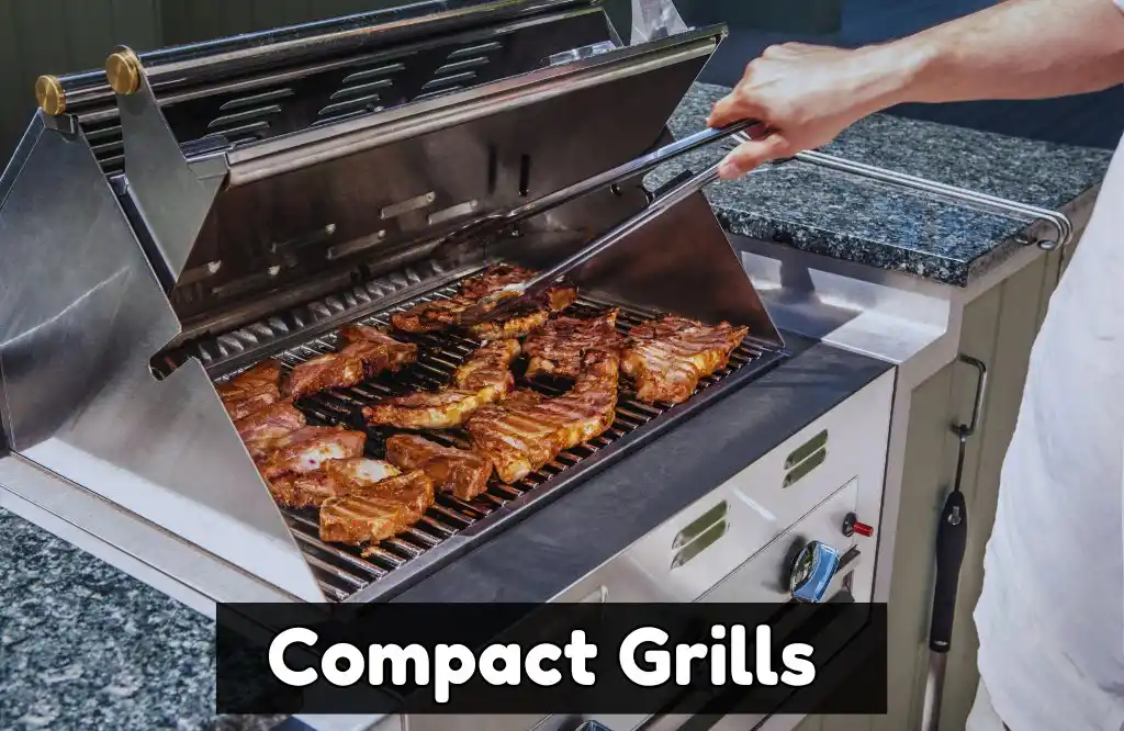 A person grilling meat on a compact stainless steel outdoor gas grill with a marble countertop, featuring pork ribs and other cuts of meat.