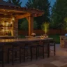 Elegant outdoor kitchen bar with stone walls and dim lighting