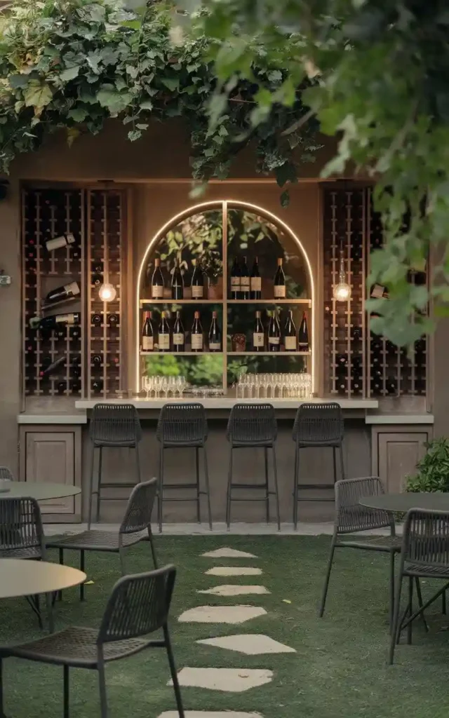 Elegant wine bar with a wine rack, glassware, and a cozy outdoor seating area for wine tasting.