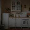 Charming small kitchen with a compact design, potted plants, and smart storage